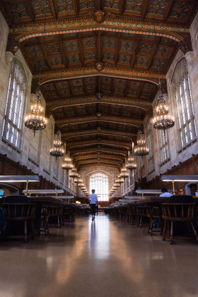 Student walking in the reading room of the Law Library